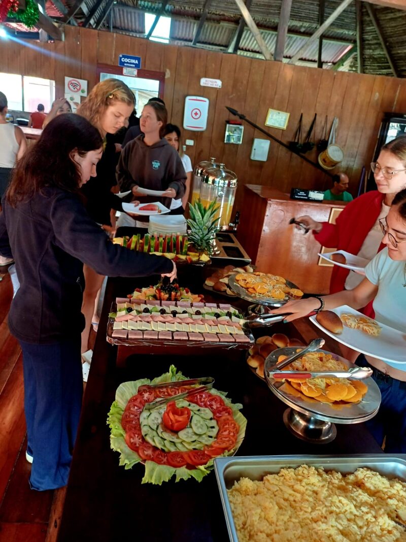 Guests serving themselves at the buffet of Cuyabeno Dolphin Lodge