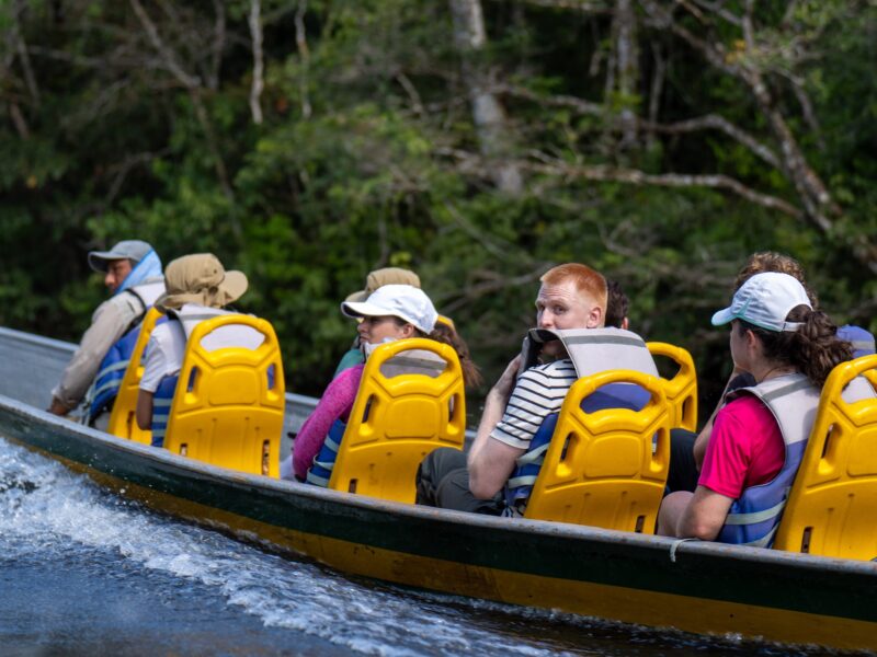 Travelers on a canoe safari in the Cuyabeno Wildlife Reserve