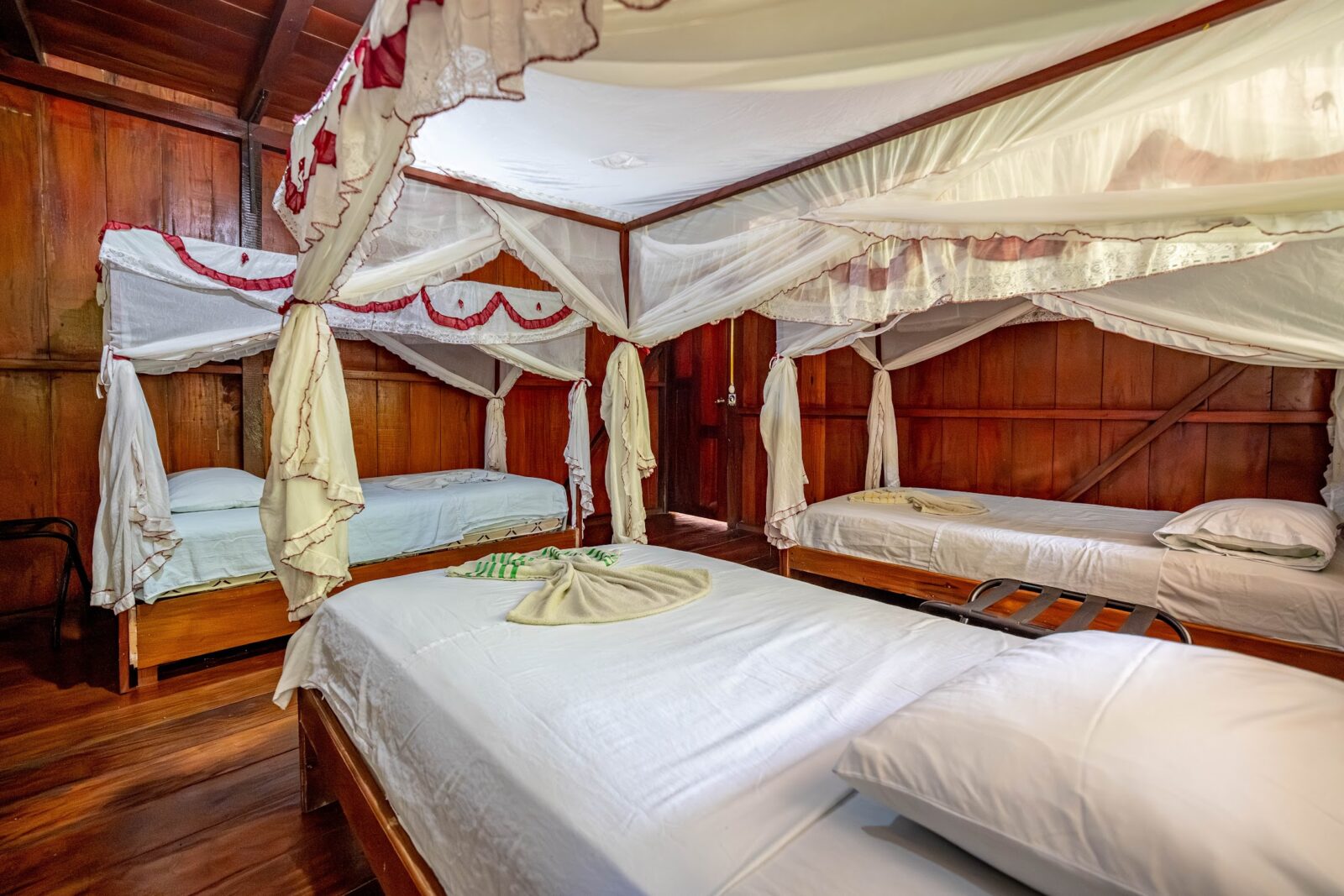 Family room with canopy beds at Cuyabeno Dolphin Lodge