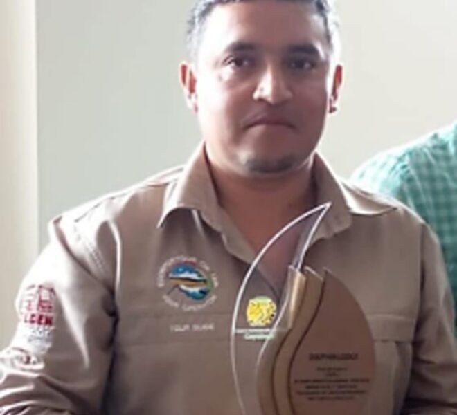 Juan Carlos Nuñez, manager and CEO of Cuyabeno Dolphin Lodge, holding an award