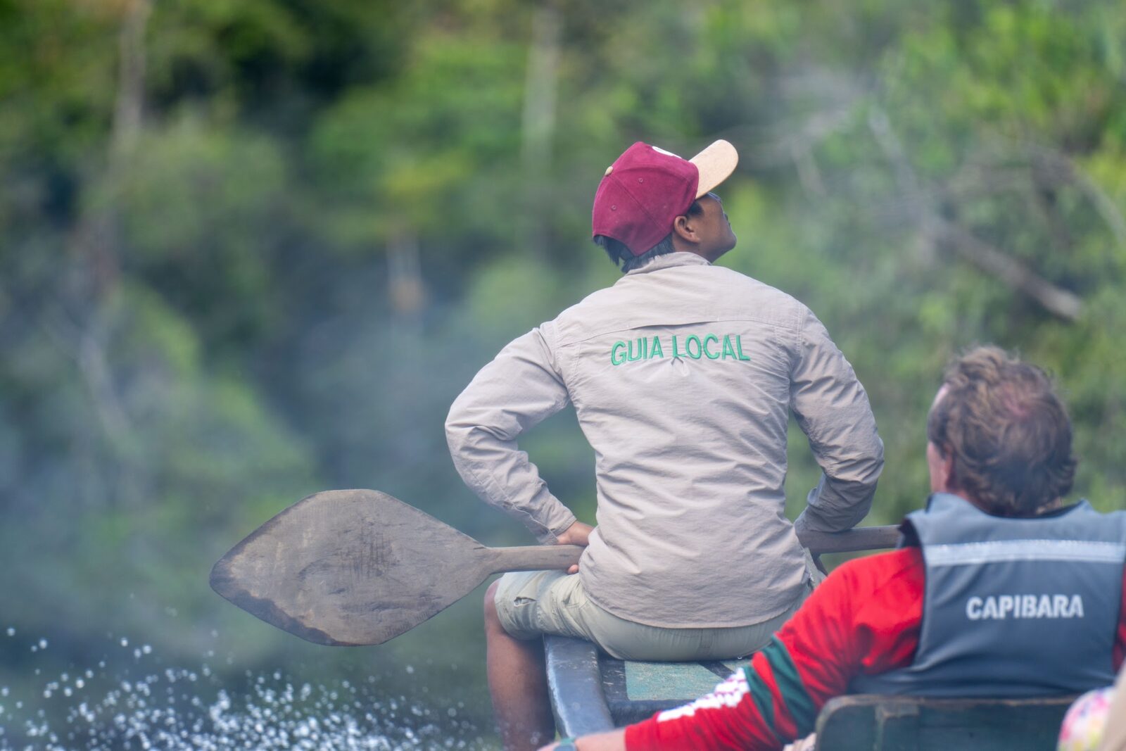 Local guide leading a motorized canoe ride through the Cuyabeno Reserve
