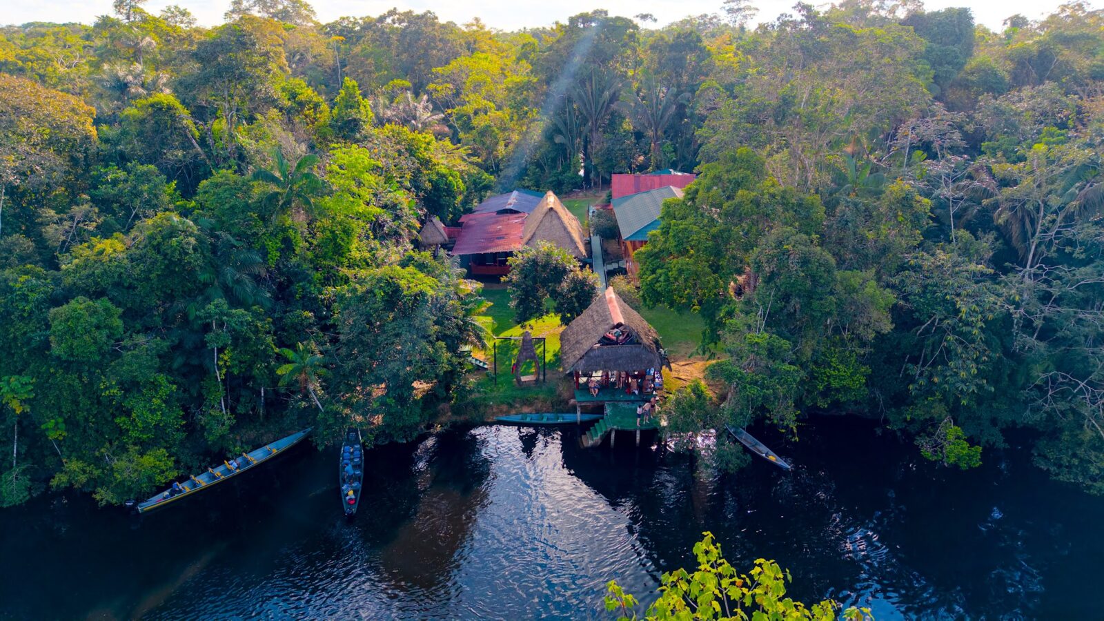 Aerial view of Cuyabeno Dolphin Lodge beside the lagoon