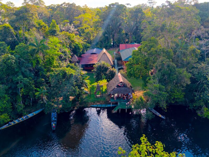 Aerial view of Cuyabeno Dolphin Lodge beside the lagoon