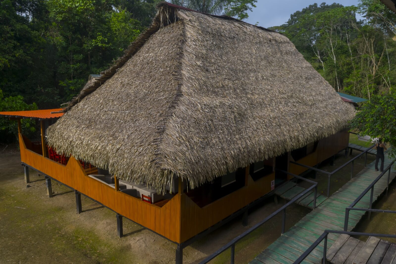 The thatched main house of Cuyabeno Dolphin Lodge