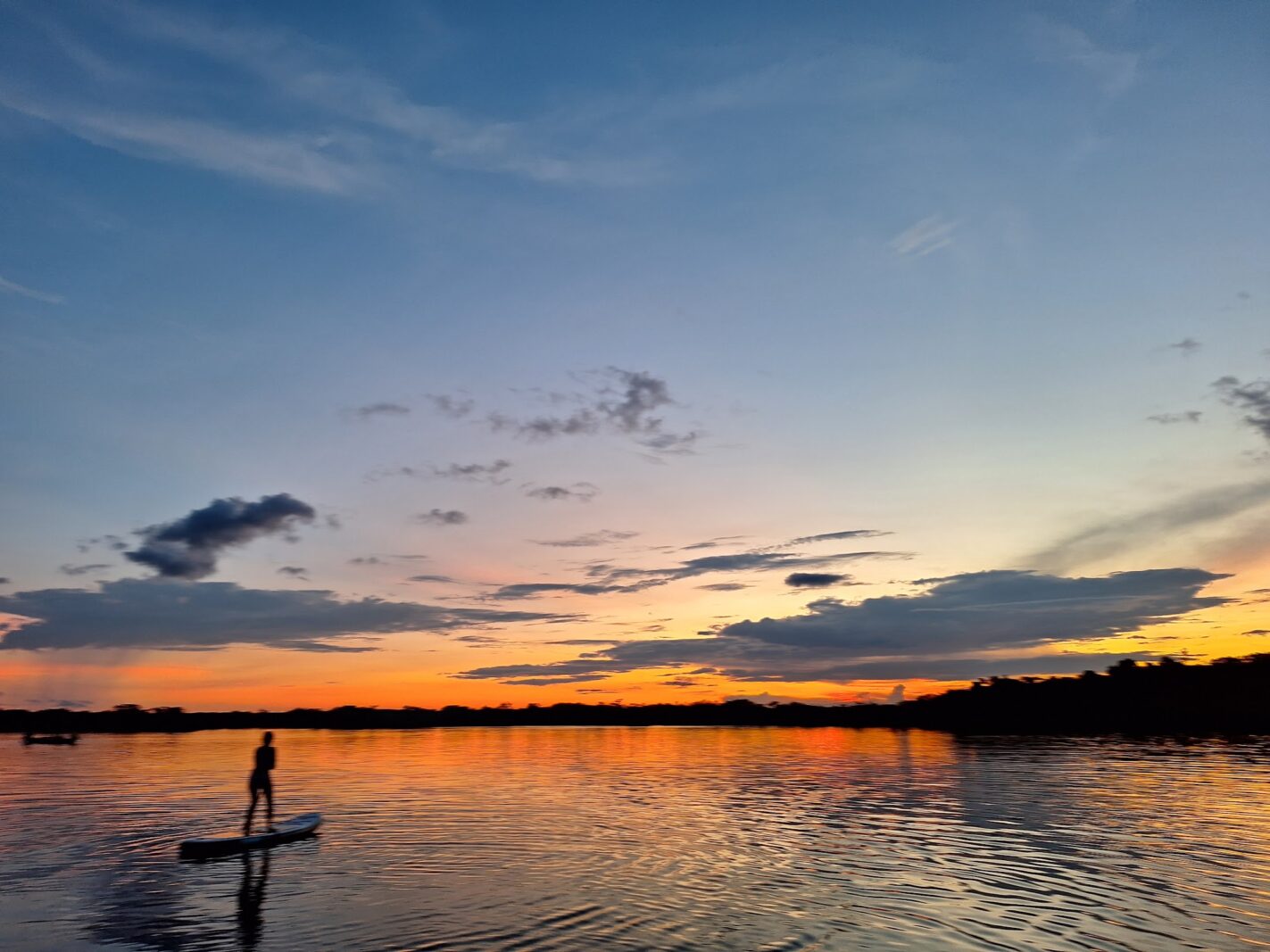 Paddleboarding on the lagoon at sunset in Cuyabeno