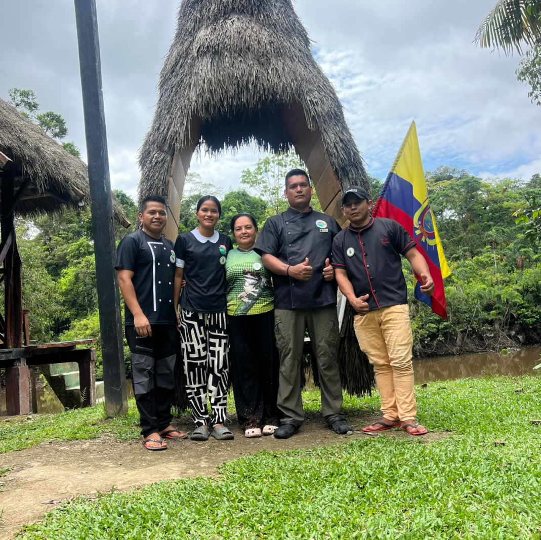 The staff of Cuyabeno Dolphin Lodge in front of the lodge entrance