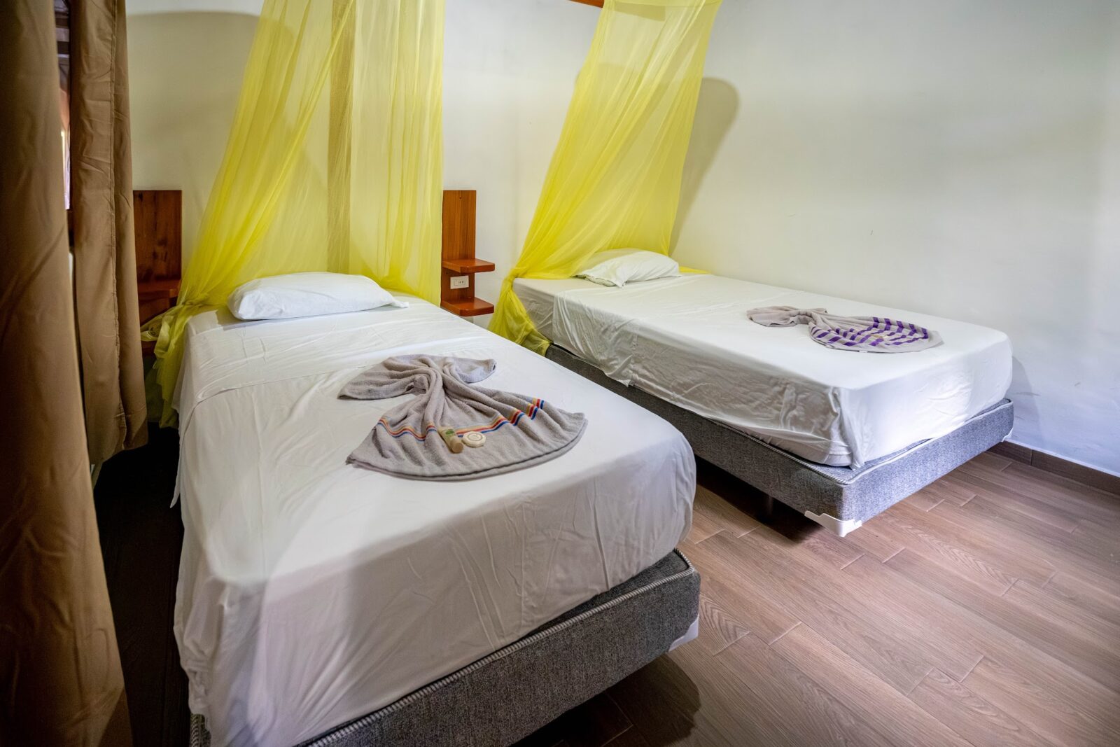 Twin beds with canopy nets at Cuyabeno Dolphin Lodge